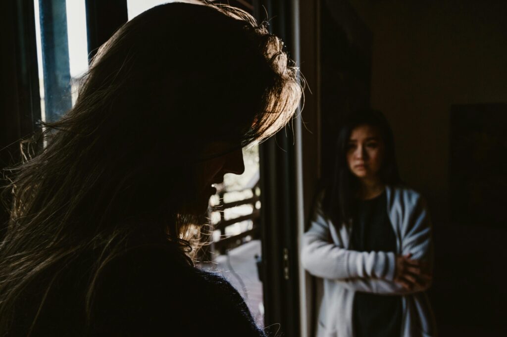 two women arguing about a past extramarital affair