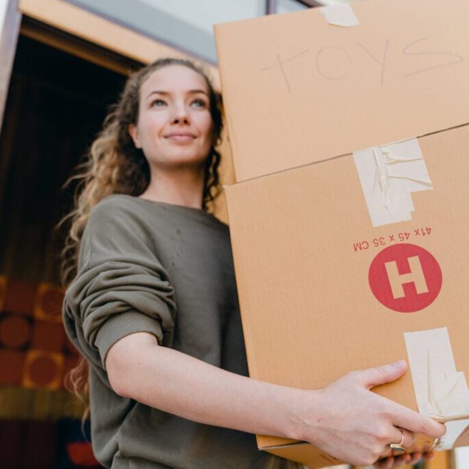 person lifting moving boxes