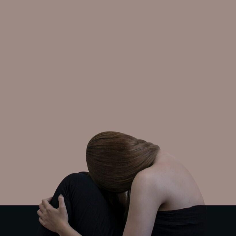 person sitting down with a strong physical reaction