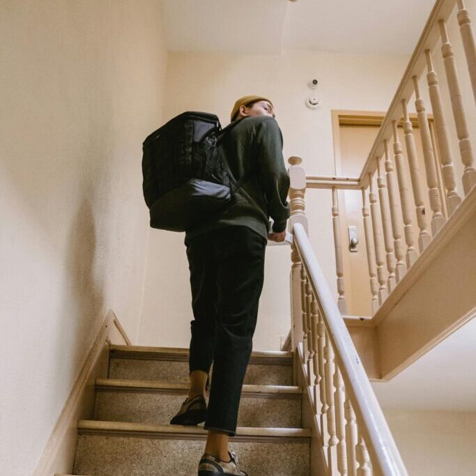 person walking up stairs scanning the floor above